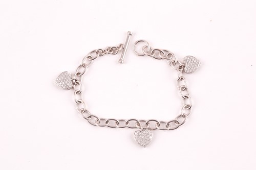 Lot 229 - An 18ct white gold charm bracelet, suspended...