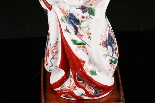 Lot 119 - A Japanese Edo period porcelain figure of a...