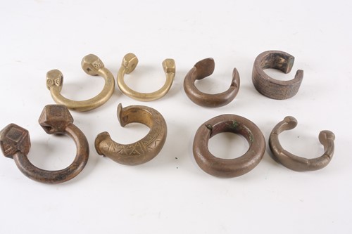 Lot 228 - Seven African bronze and brass Manillas, 19th...