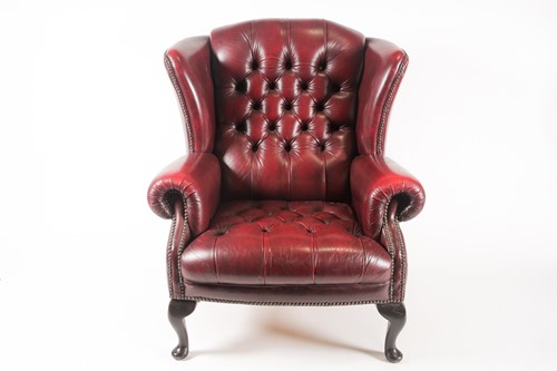 Lot 309 - A red leather gentleman's wingback armchair,...