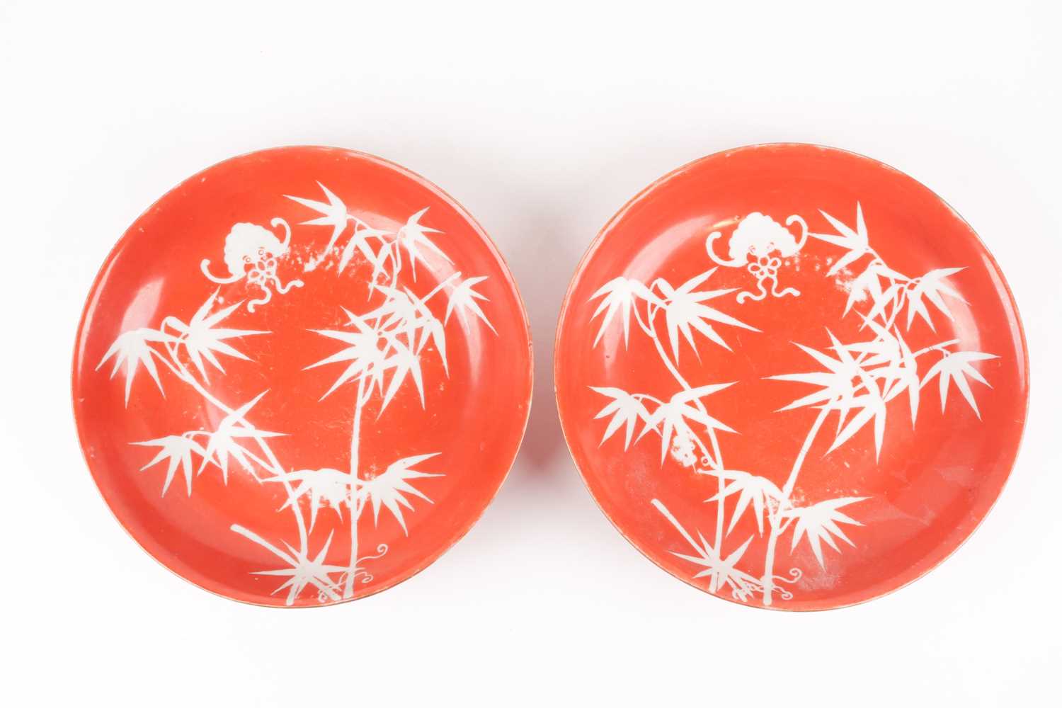 Lot 138 - A pair of coral ground reverse painted bamboo...