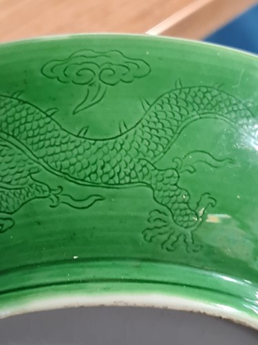 Lot 142 - A Chinese apple green glazed shallow dish,...