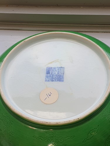 Lot 142 - A Chinese apple green glazed shallow dish,...