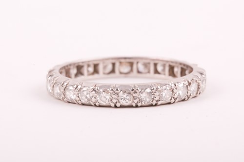 Lot 14 - A diamond eternity ring; the mixed round...