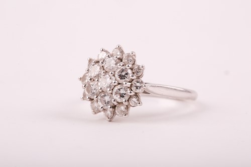 Lot 81 - A diamond cluster ring, the tired three row...