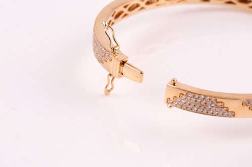 Lot 220 - An 18ct yellow gold and diamond bracelet; the...