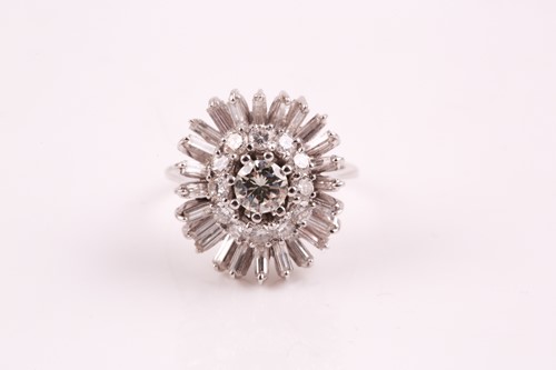 Lot 135 - A diamond cluster ring, the central brilliant...