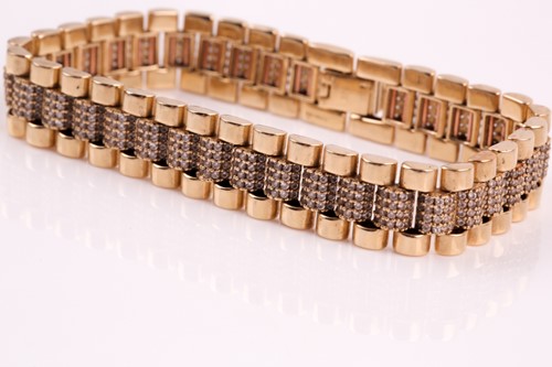 Lot 299 - A diamond bracelet, three rows of fluted links,...