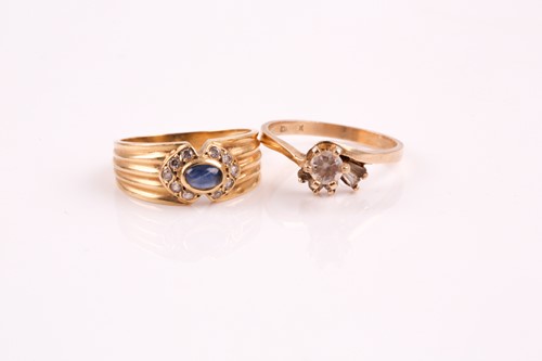 Lot 15 - A cabochon sapphire and clear stone ring, in a...