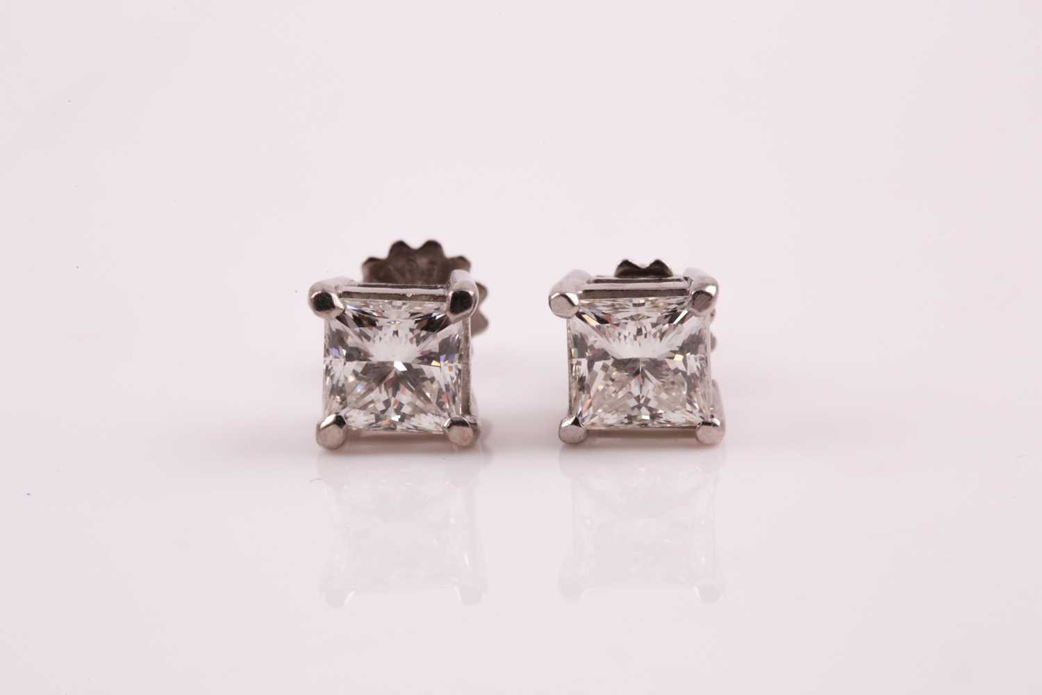 Lot 87 - A pair of diamond stud earrings; the princess...