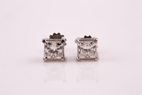 Lot 87 - A pair of diamond stud earrings; the princess...