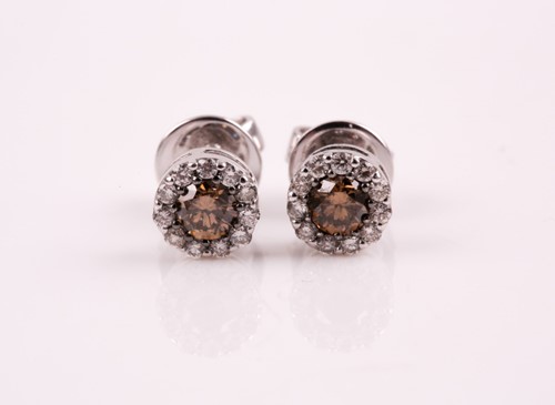 Lot 304 - A pair of diamond cluster earrings; the...