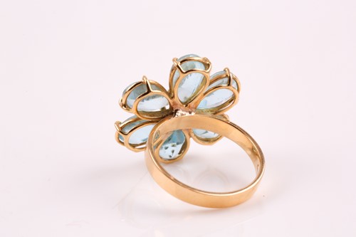 Lot 303 - A blue topaz cluster ring, the six claw...