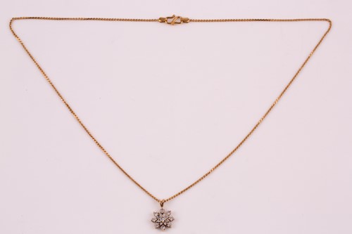 Lot 115 - A diamond cluster pendant; the round brilliant...