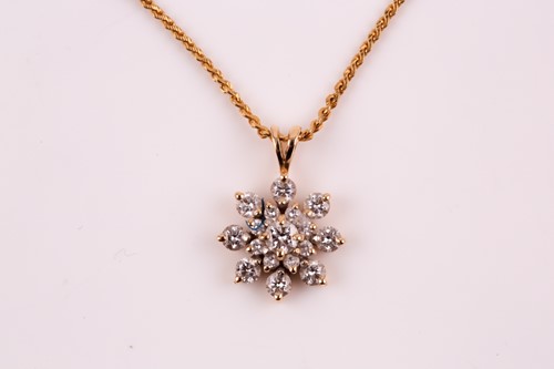Lot 115 - A diamond cluster pendant; the round brilliant...
