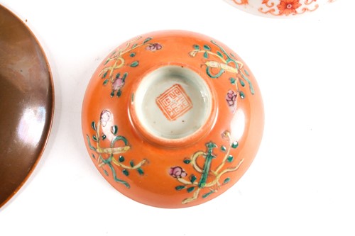 Lot 174 - A Chinese reverse decorated coral ground bowl,...