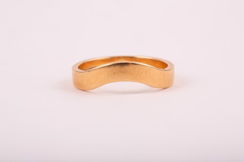 Lot 176 - An 18ct yellow gold band ring, with shaped...