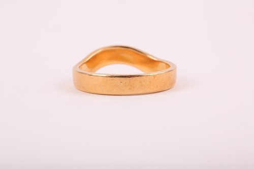 Lot 176 - An 18ct yellow gold band ring, with shaped...