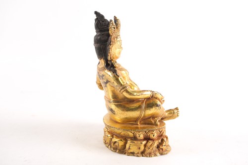 Lot 178 - A Sino Tibetan gilt-bronze figure of Jambhala...