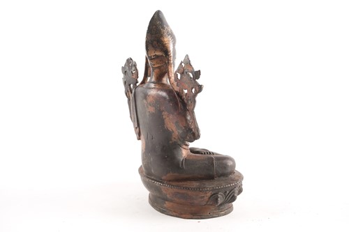 Lot 87 - A Tibetan patinated and gilt bronze figure of...