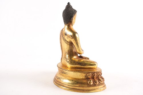 Lot 186 - A Sino Tibetan gilt-bronze figure of a seated...