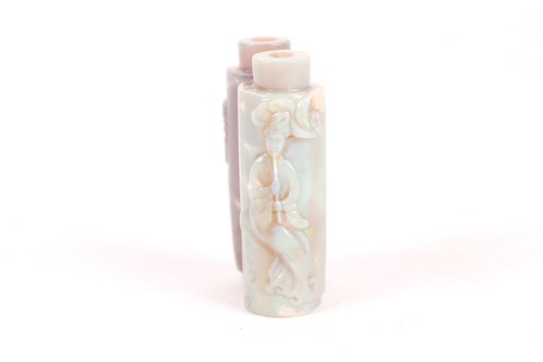 Lot 206 - A Chinese pale green iridescent, carved jade...