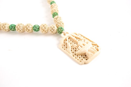 Lot 210 - A Chinese carved ivory pendant, early 20th...