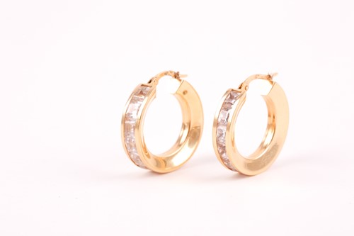 Lot 112 - A pair of yellow metal and cubic zirconia hoop...