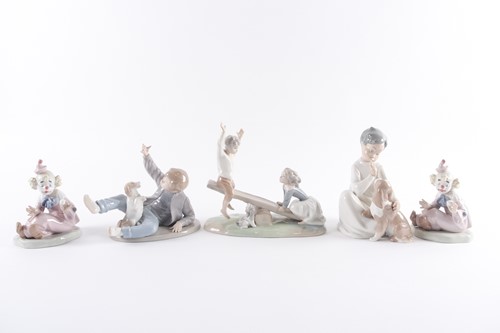 Lot 339 - A Lladro porcelain figure of a boy and girl...