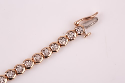 Lot 306 - A 9ct yellow gold and diamond line bracelet,...