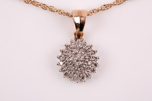 Lot 283 - A 9ct yellow gold and diamond cluster pendant,...