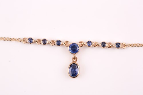 Lot 272 - A 9ct yellow gold and sapphire drop pendant...