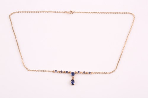 Lot 272 - A 9ct yellow gold and sapphire drop pendant...