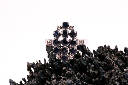Lot 293 - A sapphire and diamond cluster dress ring,...