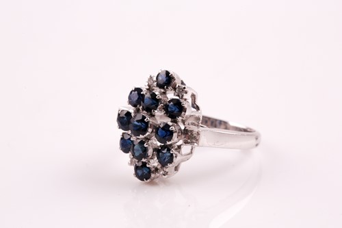 Lot 293 - A sapphire and diamond cluster dress ring,...