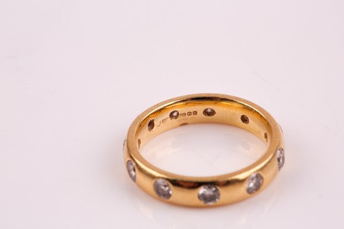 Lot 357 - An 18ct gold and diamond full hoop ring, the...