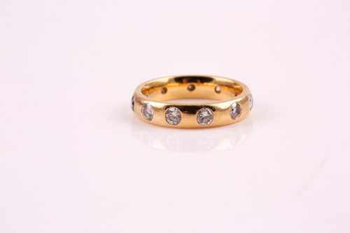 Lot 357 - An 18ct gold and diamond full hoop ring, the...