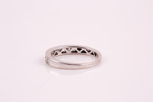 Lot 250 - A nine stone half hoop eternity ring; the...