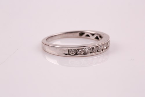Lot 250 - A nine stone half hoop eternity ring; the...