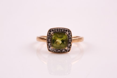 Lot 183 - A peridot and diamond cluster ring, the...