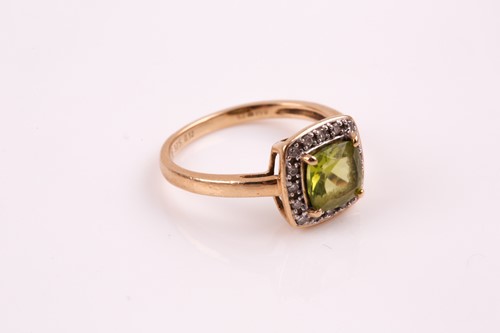 Lot 183 - A peridot and diamond cluster ring, the...