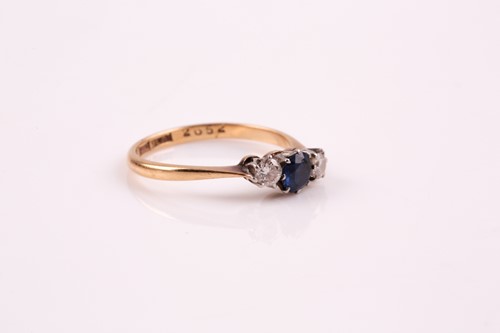 Lot 107 - A three stone half hoop sapphire and diamond...