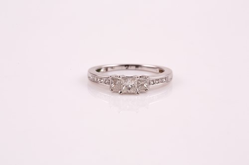 Lot 83 - A three stone half hoop diamond ring; the...