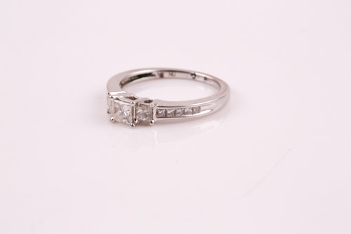 Lot 83 - A three stone half hoop diamond ring; the...