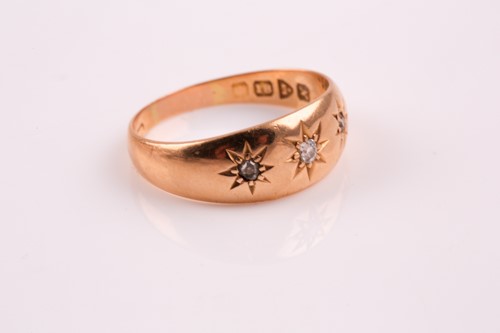 Lot 345 - A three stone diamond ring; the slightly...