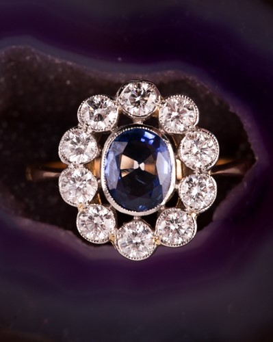 Lot 82 - A diamond and sapphire ring, collet-set with a...