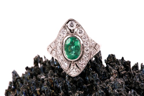 Lot 13 - A platinum, diamond, and emerald ring, set...