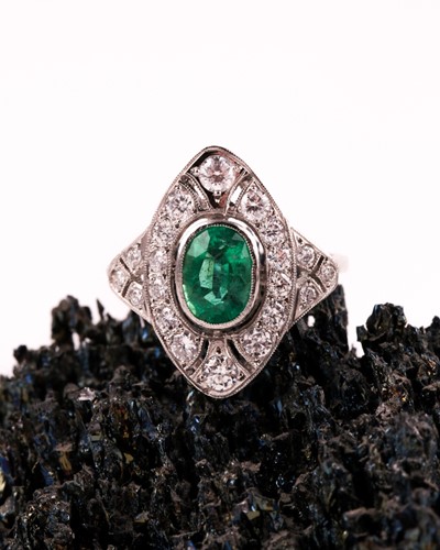 Lot 13 - A platinum, diamond, and emerald ring, set...