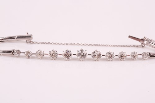 Lot 295 - A platinum and diamond bracelet, set with...