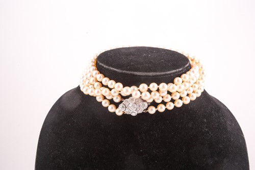Lot 109 - A double strand pearl necklace, set with a...